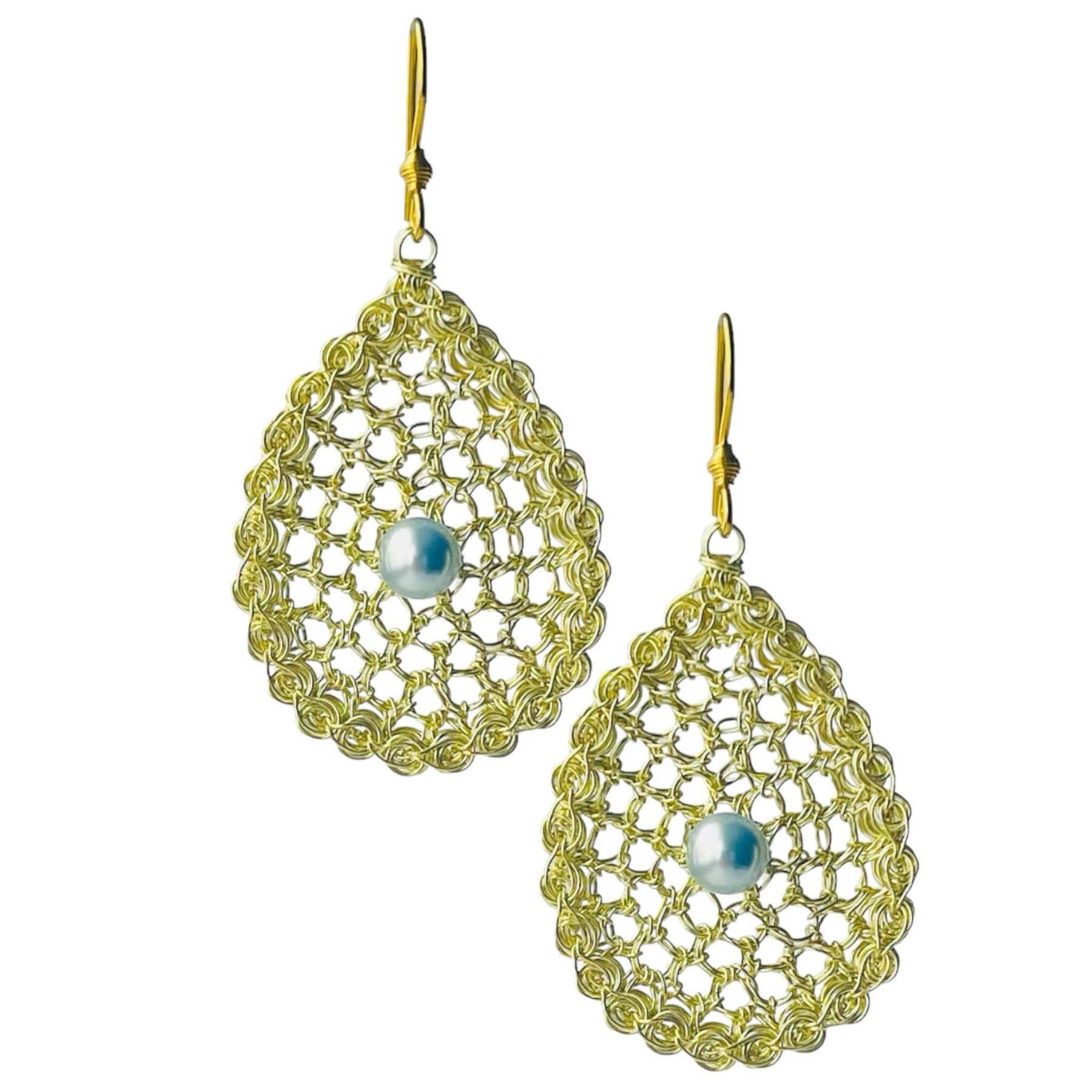 woman handmade earrings in golden wire