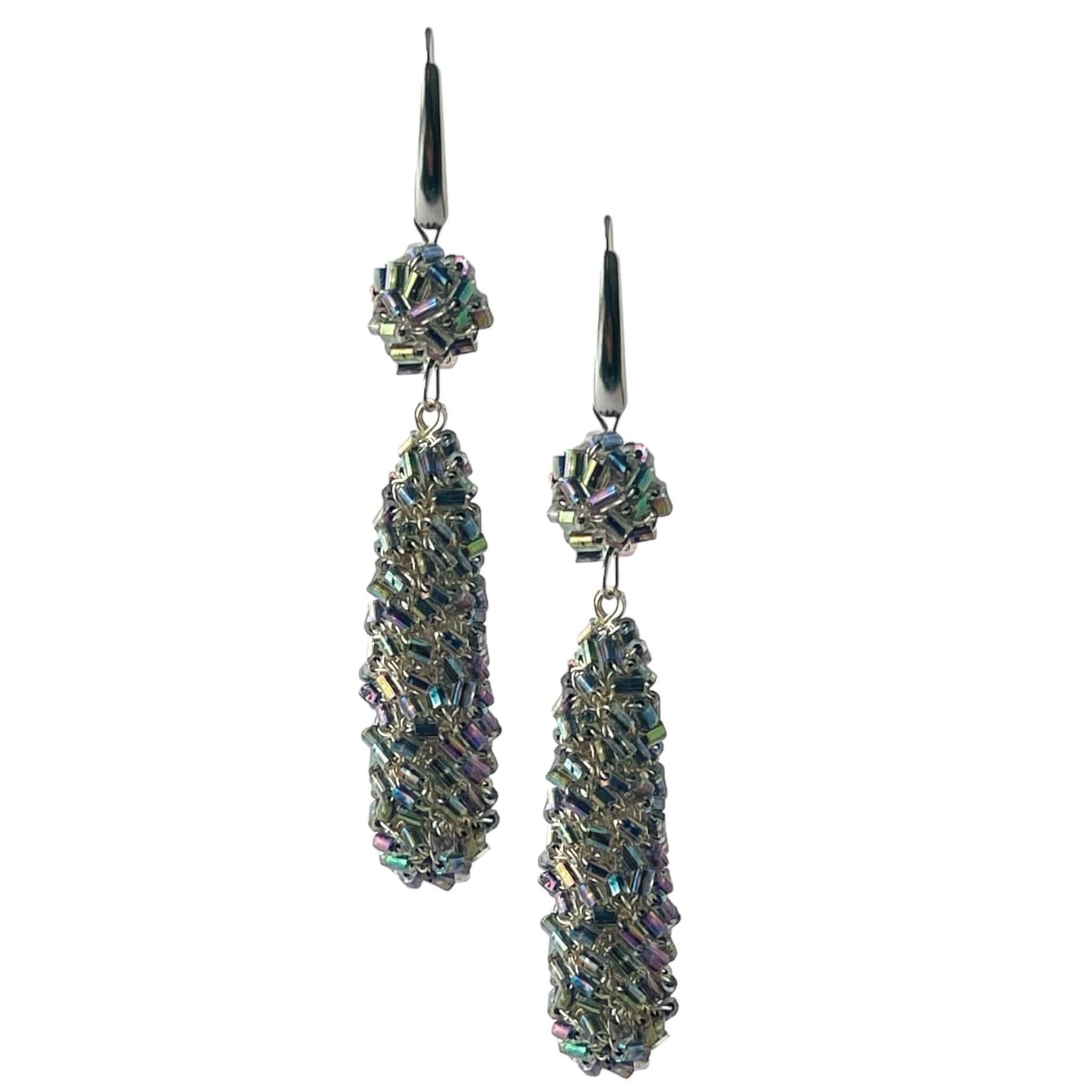 woman handmade earrings in silver wire