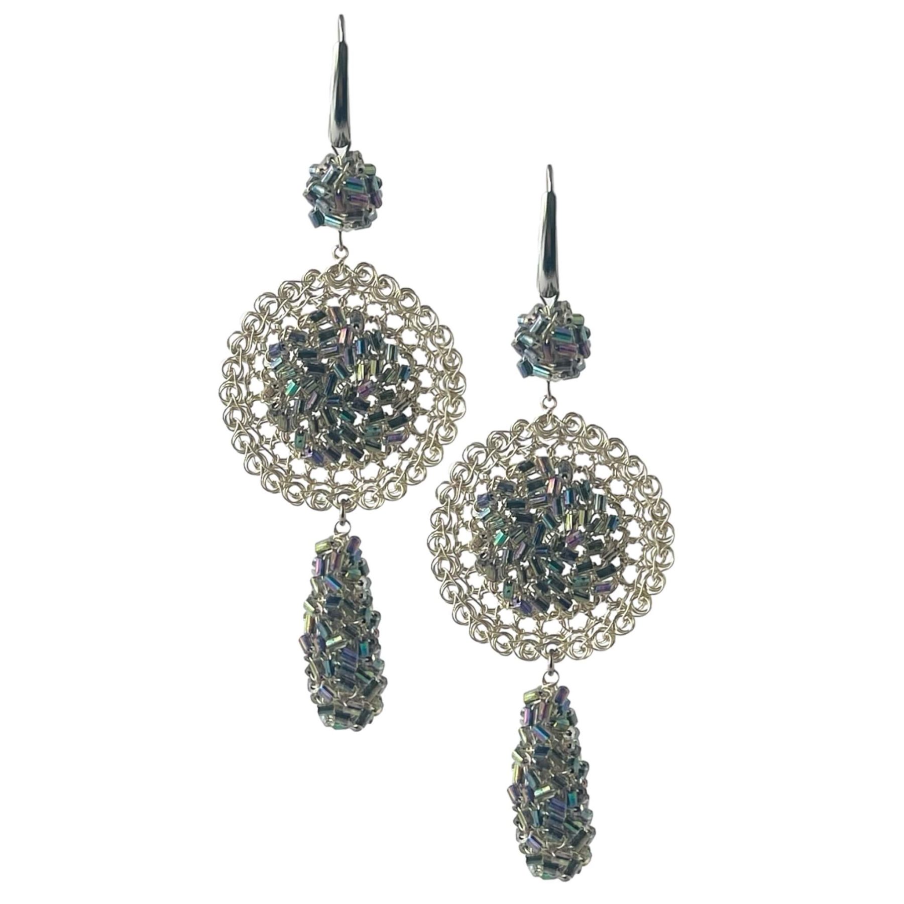 woman handmade earrings in silver wire