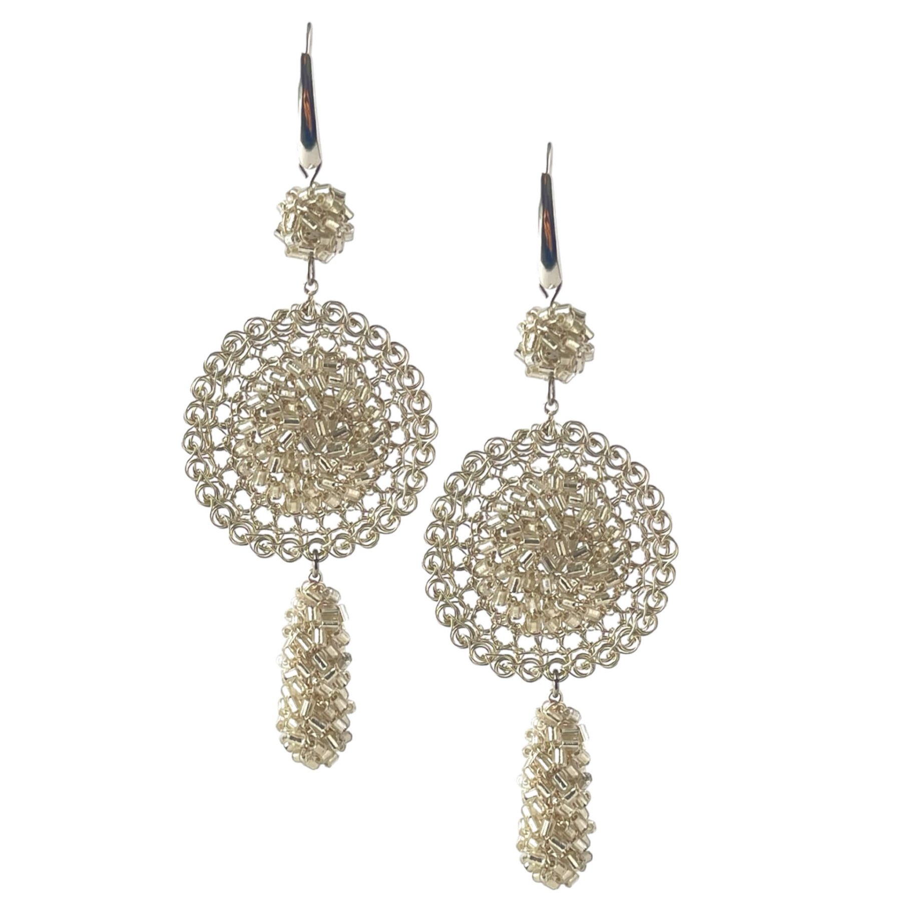 woman handmade earrings in silver wire