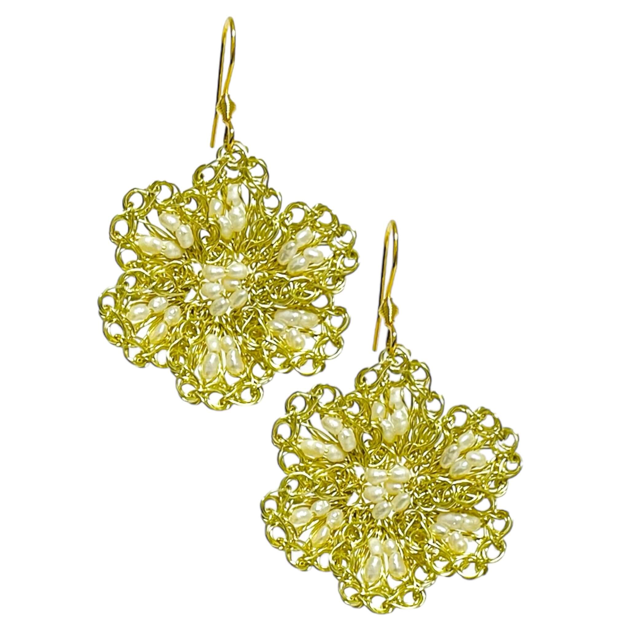 woman handmade earrings in golden wire woman handmade earrings in golden wire